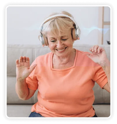 Smiling woman wearing headphones while listening to The Memory Wave gamma sound session
